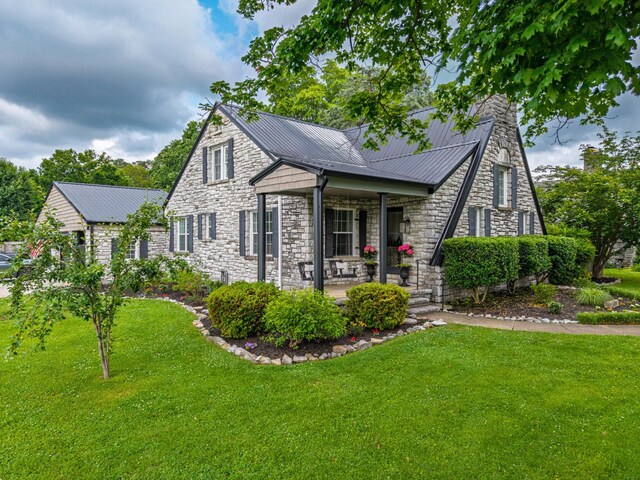 813 Swanson Blvd, Fayetteville, TN 37334 - view of front of house featuring stone siding, a front lawn, and metal roof