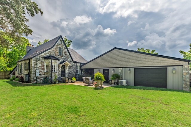 813 Swanson Blvd, Fayetteville, TN 37334 - back of property featuring stone siding, a lawn, an attached garage, a patio area, and ac unit