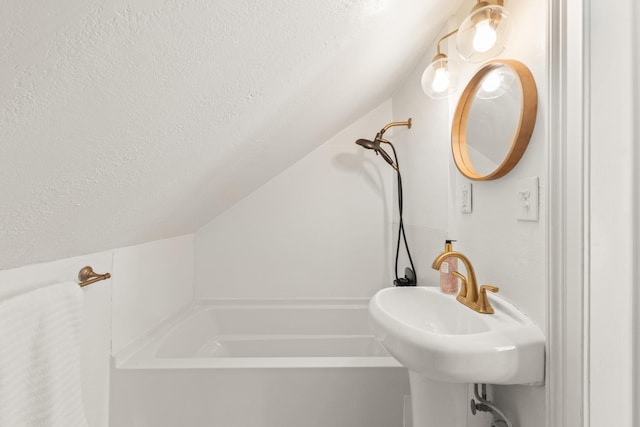 813 Swanson Blvd, Fayetteville, TN 37334 - full bath featuring a textured ceiling, vaulted ceiling, a tub, and a sink