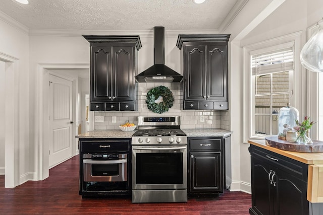 813 Swanson Blvd, Fayetteville, TN 37334 - kitchen featuring appliances with stainless steel finishes, wall chimney range hood, dark wood-style floors, decorative backsplash, and dark cabinetry