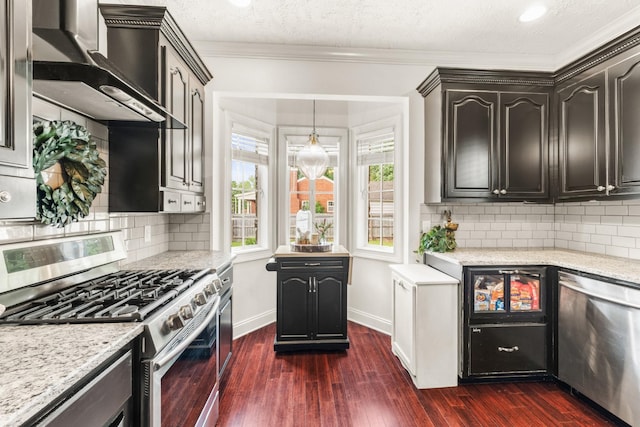 813 Swanson Blvd, Fayetteville, TN 37334 - kitchen with stainless steel appliances, wall chimney exhaust hood, healthy amount of natural light, dark wood-style floors, and crown molding