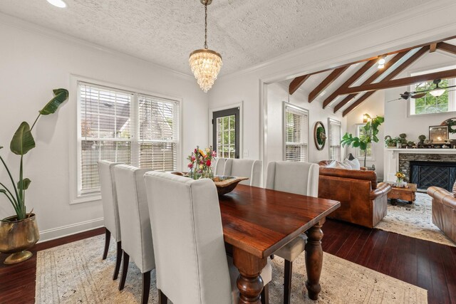 813 Swanson Blvd, Fayetteville, TN 37334 - dining area featuring a chandelier, a stone fireplace, wood-type flooring, a textured ceiling, and baseboards