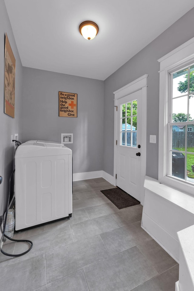 entryway featuring baseboards and washer / dryer