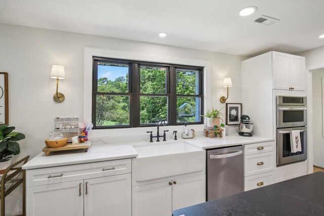 4151 Sadlersville Rd, Adams, TN 37010 - kitchen featuring appliances with stainless steel finishes, a sink, white cabinetry, recessed lighting, and light stone countertops
