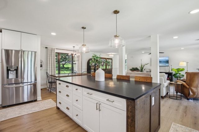 4151 Sadlersville Rd, Adams, TN 37010 - kitchen featuring stainless steel fridge with ice dispenser, dark countertops, light wood-style floors, and recessed lighting