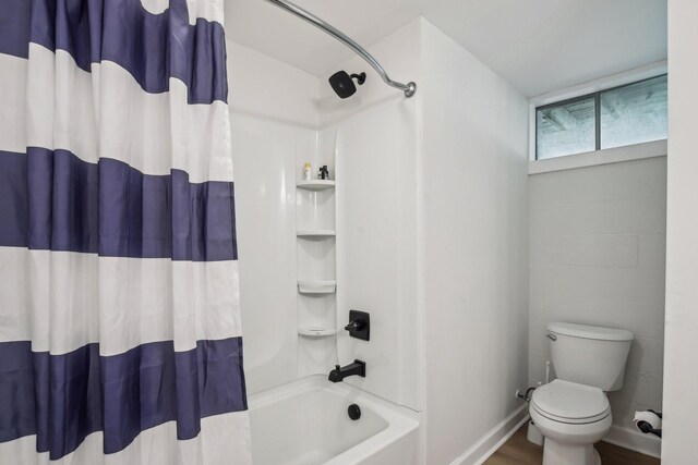 4151 Sadlersville Rd, Adams, TN 37010 - bathroom featuring shower / tub combo, toilet, and baseboards
