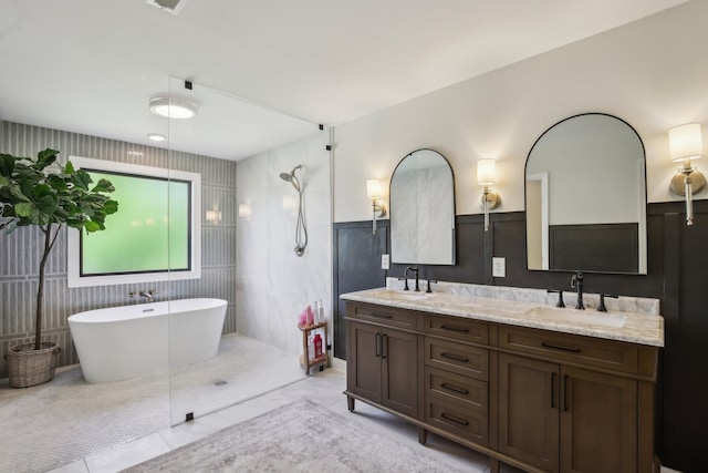 4151 Sadlersville Rd, Adams, TN 37010 - full bathroom with double vanity, a freestanding tub, a shower, wainscoting, and tile patterned flooring