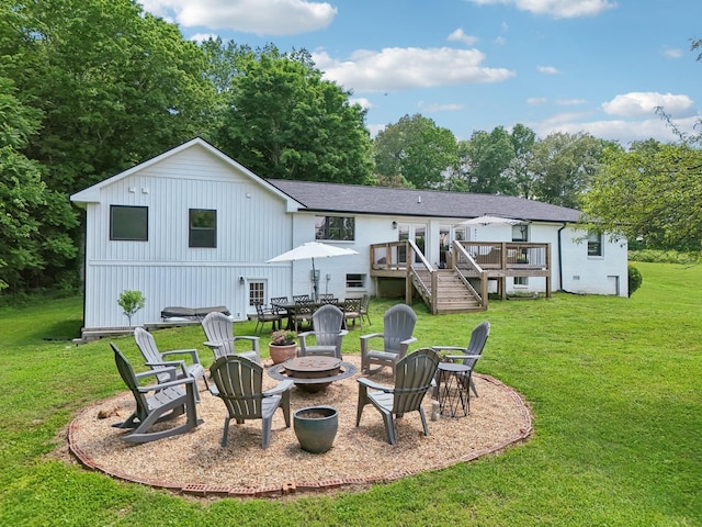 4151 Sadlersville Rd, Adams, TN 37010 - back of property featuring an outdoor fire pit, a wooden deck, a lawn, stairs, and view of wooded area