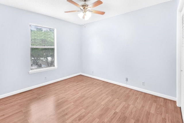 unfurnished room with light wood finished floors, baseboards, and ceiling fan