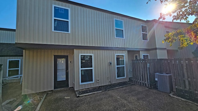 rear view of property with fence and cooling unit