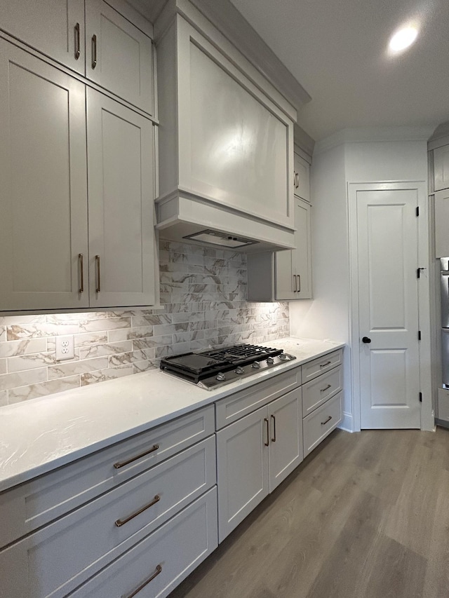 5742 Sagebrush Dr, Murfreesboro, TN 37129 - kitchen with stainless steel gas stovetop, light wood finished floors, tasteful backsplash, light countertops, and gray cabinets