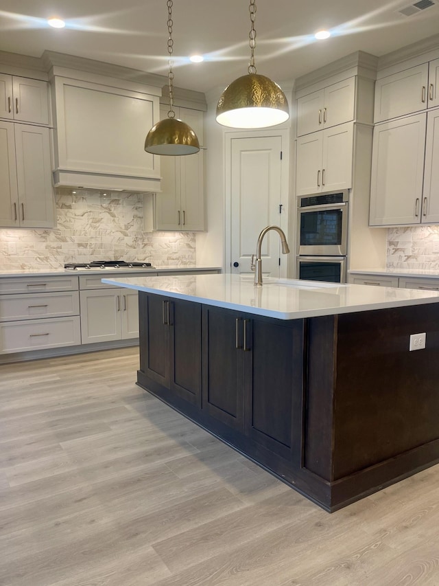 5742 Sagebrush Dr, Murfreesboro, TN 37129 - kitchen featuring stainless steel appliances, light countertops, light wood-style flooring, tasteful backsplash, and recessed lighting