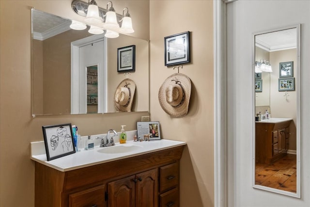 bathroom featuring crown molding, vanity, and a chandelier