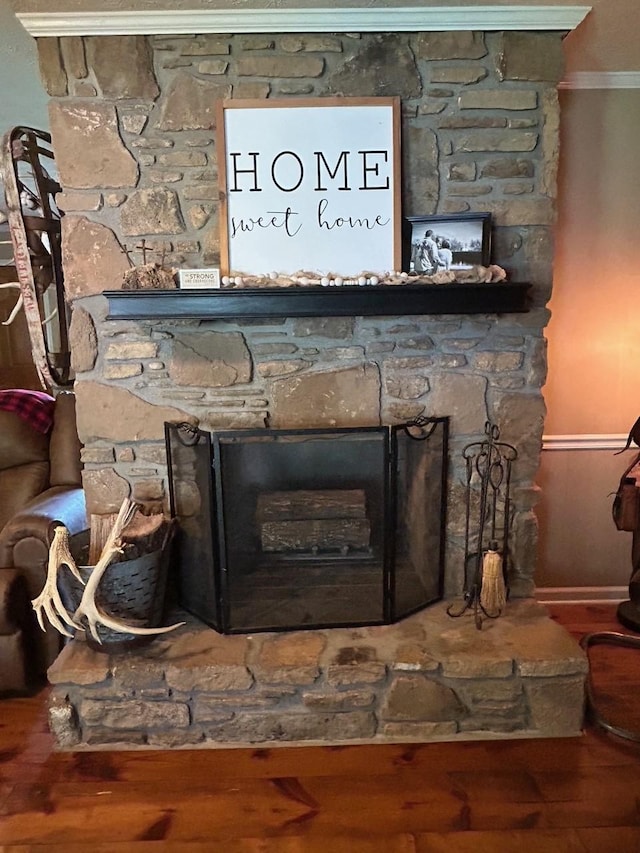detailed view of a fireplace and wood finished floors