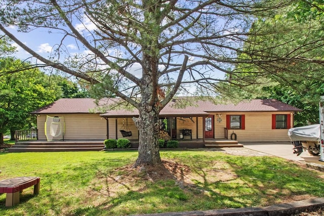 back of house with a lawn and a patio area