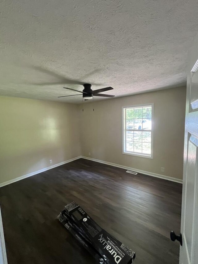 8315 Oak Springs Rd, Nunnelly, TN 37137 - spare room with dark wood-type flooring, baseboards, a ceiling fan, and a textured ceiling