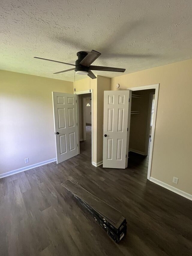 8315 Oak Springs Rd, Nunnelly, TN 37137 - unfurnished bedroom featuring dark wood finished floors, baseboards, a textured ceiling, and a ceiling fan