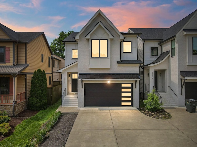 1541 Battlefield Dr Unit A, Nashville, TN 37215 - view of front of home featuring driveway, a garage, brick siding, and a standing seam roof