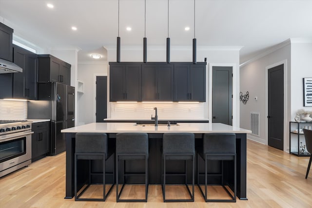 1541 Battlefield Dr Unit A, Nashville, TN 37215 - kitchen with stainless steel appliances, a sink, crown molding, decorative backsplash, and light countertops