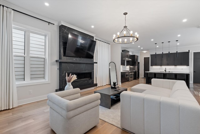 1541 Battlefield Dr Unit A, Nashville, TN 37215 - living area with recessed lighting, a chandelier, light wood-style flooring, baseboards, and a premium fireplace
