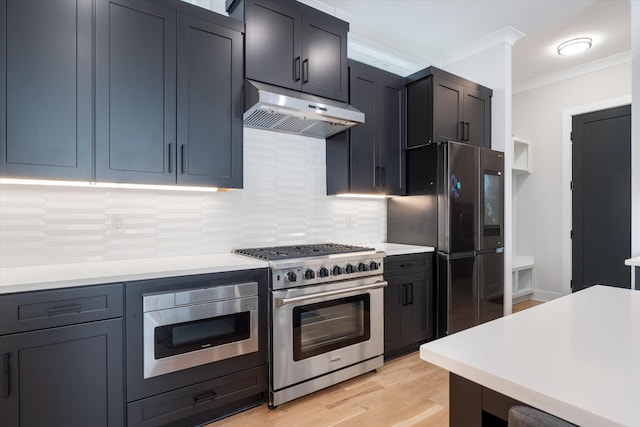1541 Battlefield Dr Unit A, Nashville, TN 37215 - kitchen with stainless steel appliances, under cabinet range hood, ornamental molding, light countertops, and decorative backsplash