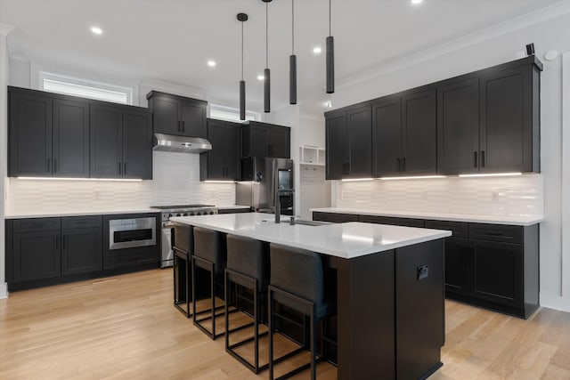 1541 Battlefield Dr Unit A, Nashville, TN 37215 - kitchen with gas range, freestanding refrigerator, under cabinet range hood, a sink, and dark cabinetry