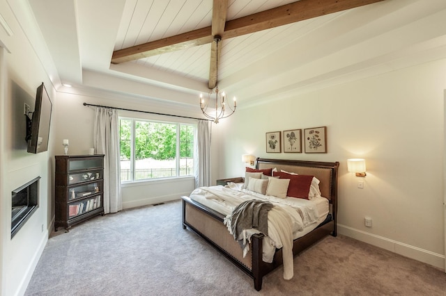 bedroom with beamed ceiling, a chandelier, carpet flooring, wooden ceiling, and baseboards