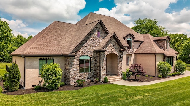french country inspired facade featuring stone siding, a front yard, and roof with shingles