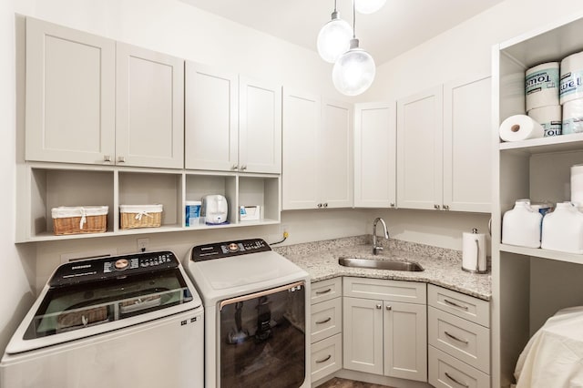 washroom featuring washing machine and clothes dryer and cabinet space