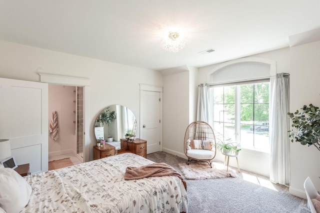 bedroom with baseboards and carpet