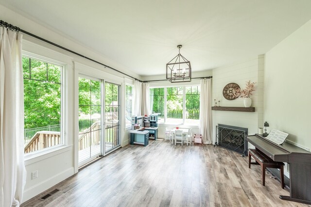sunroom / solarium with healthy amount of natural light and a chandelier