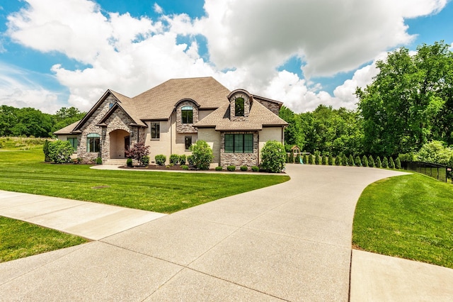 french country home featuring stone siding