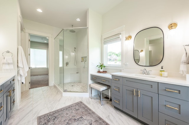 full bathroom featuring plenty of natural light, a stall shower, vanity, and baseboards