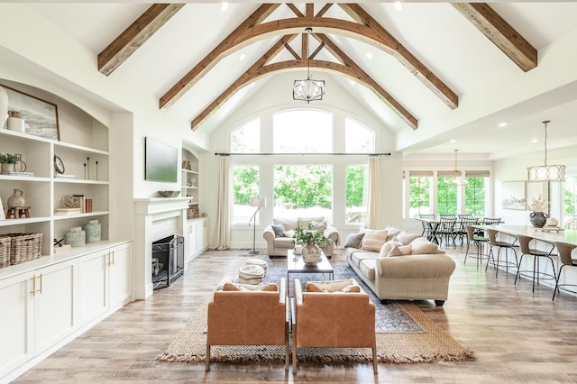 living room with a chandelier, high vaulted ceiling, beam ceiling, a fireplace, and recessed lighting