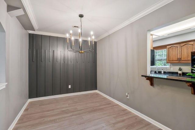 123 Eastdale Ln, Dickson, TN 37055 - unfurnished dining area featuring a chandelier, light wood finished floors, crown molding, and baseboards