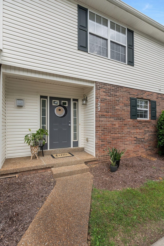 123 Eastdale Ln, Dickson, TN 37055 - view of exterior entry featuring a porch and brick siding