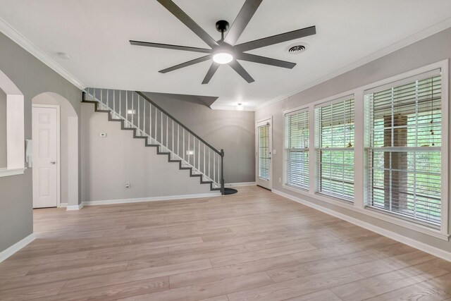 123 Eastdale Ln, Dickson, TN 37055 - unfurnished living room featuring crown molding, a ceiling fan, baseboards, stairs, and light wood-style flooring