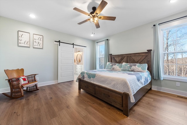 170 Autumn Trl, Dover, TN 37058 - bedroom with a barn door, wood finished floors, baseboards, recessed lighting, and ceiling fan