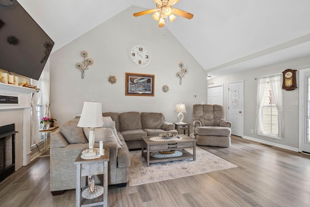 1172 Country Fields Ln, Clarksville, TN 37040 - living room featuring a tile fireplace, high vaulted ceiling, a ceiling fan, wood finished floors, and baseboards