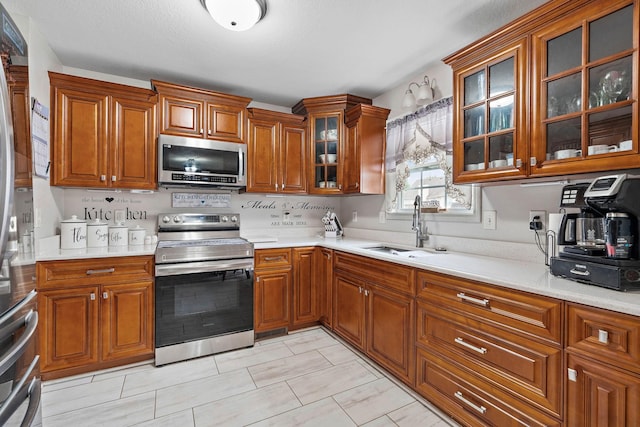 1172 Country Fields Ln, Clarksville, TN 37040 - kitchen featuring stainless steel appliances, brown cabinets, a sink, and light countertops