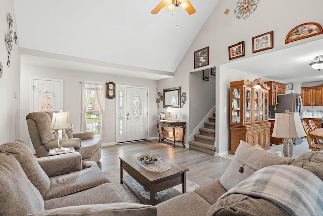 1172 Country Fields Ln, Clarksville, TN 37040 - living room featuring high vaulted ceiling, ceiling fan, light wood-type flooring, stairway, and baseboards
