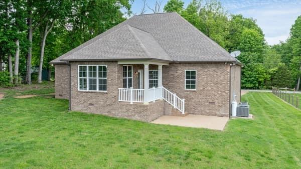 683 Northup Rd, Portland, TN 37148 - rear view of house with brick siding, central AC, a patio, and crawl space
