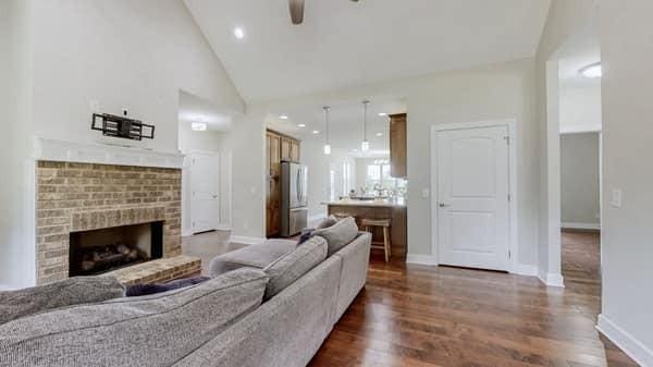 683 Northup Rd, Portland, TN 37148 - living area featuring a ceiling fan, dark wood finished floors, a brick fireplace, baseboards, and high vaulted ceiling