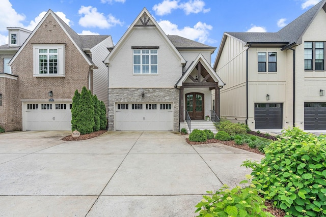1501 Woodmont Blvd Unit B, Nashville, TN 37215 - view of front of home with driveway, stone siding, a garage, and board and batten siding
