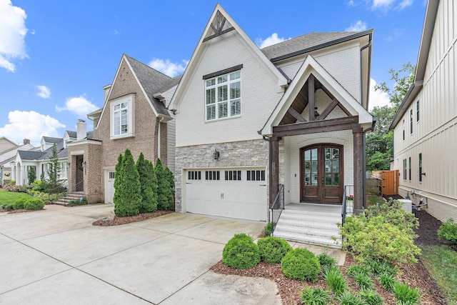 1501 Woodmont Blvd Unit B, Nashville, TN 37215 - view of front of property with french doors, driveway, an attached garage, brick siding, and a shingled roof