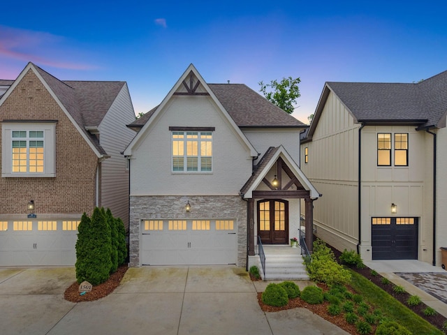 1501 Woodmont Blvd Unit B, Nashville, TN 37215 - view of front of house with french doors, concrete driveway, stone siding, and a garage