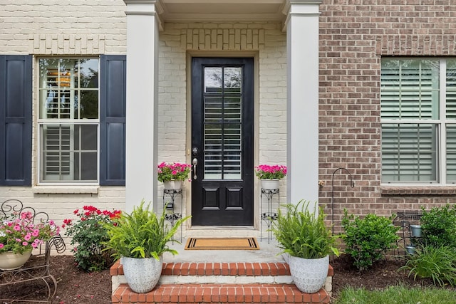 property entrance with brick siding