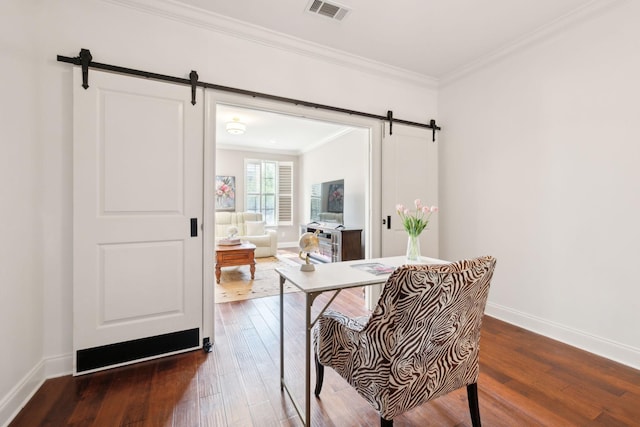 dining area featuring a barn door, hardwood / wood-style floors, ornamental molding, and baseboards