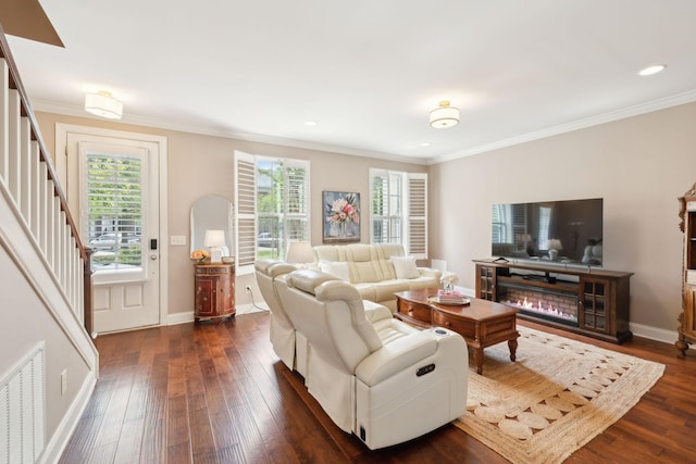 living room featuring dark wood finished floors, crown molding, stairway, baseboards, and recessed lighting