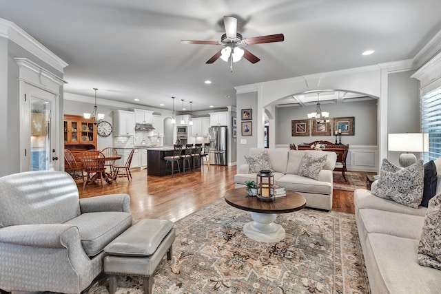 6018 Trotwood Ln, Spring Hill, TN 37174 - living area featuring wood finished floors, arched walkways, ceiling fan, a chandelier, and recessed lighting